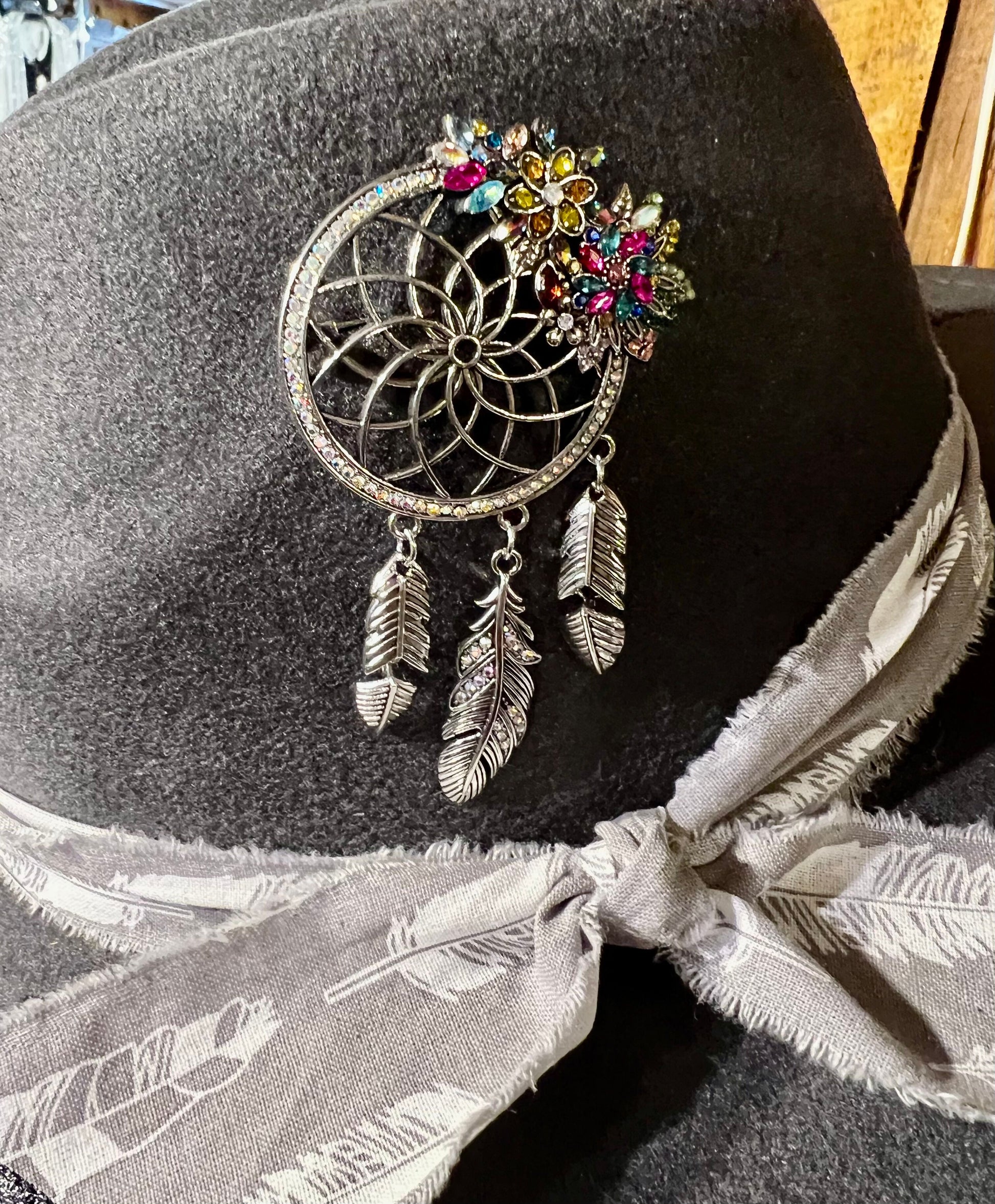Western hat with dream weaver piece and burnt feathers