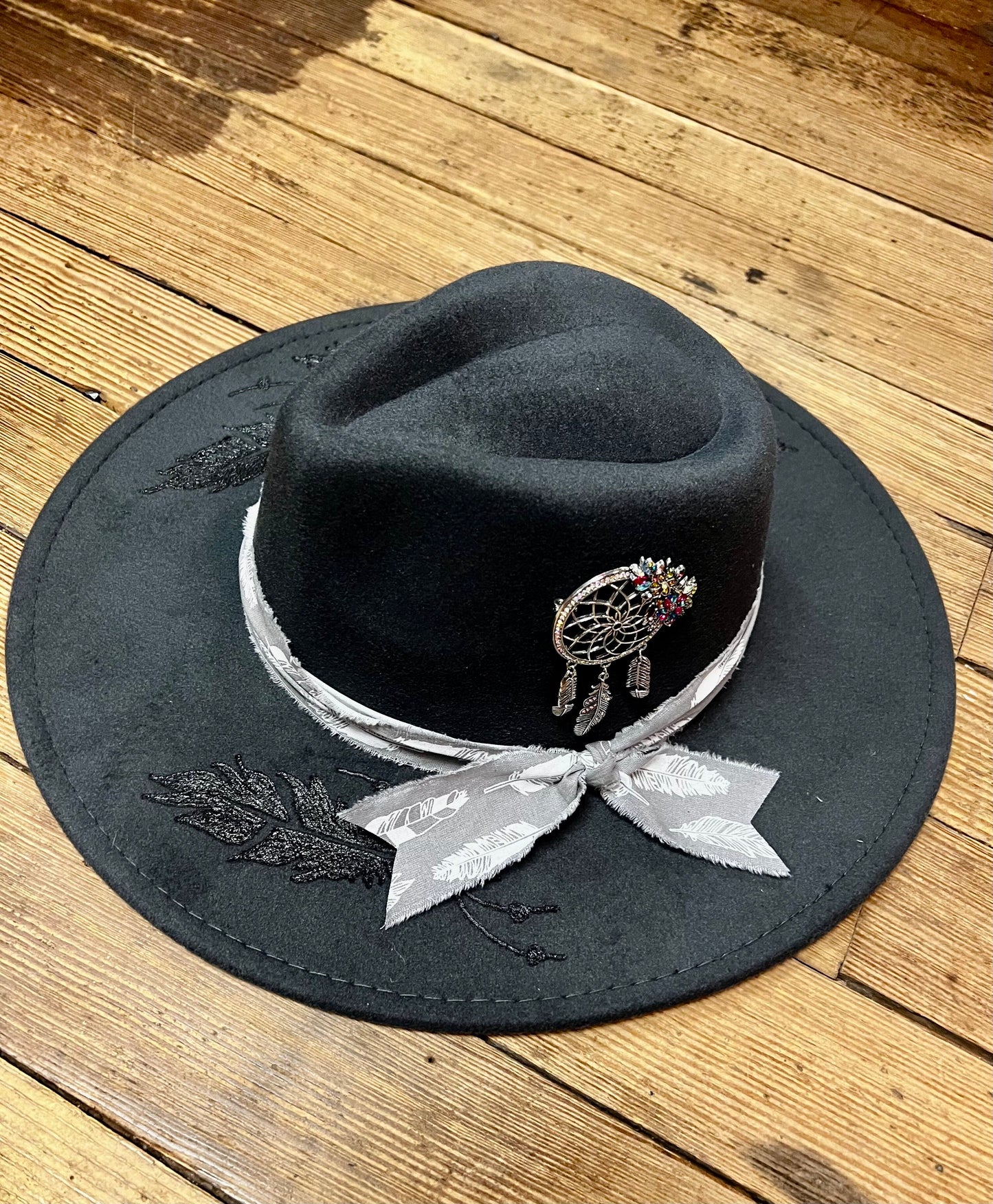 Western Hat with burnt feathers and dream weaver adornment
